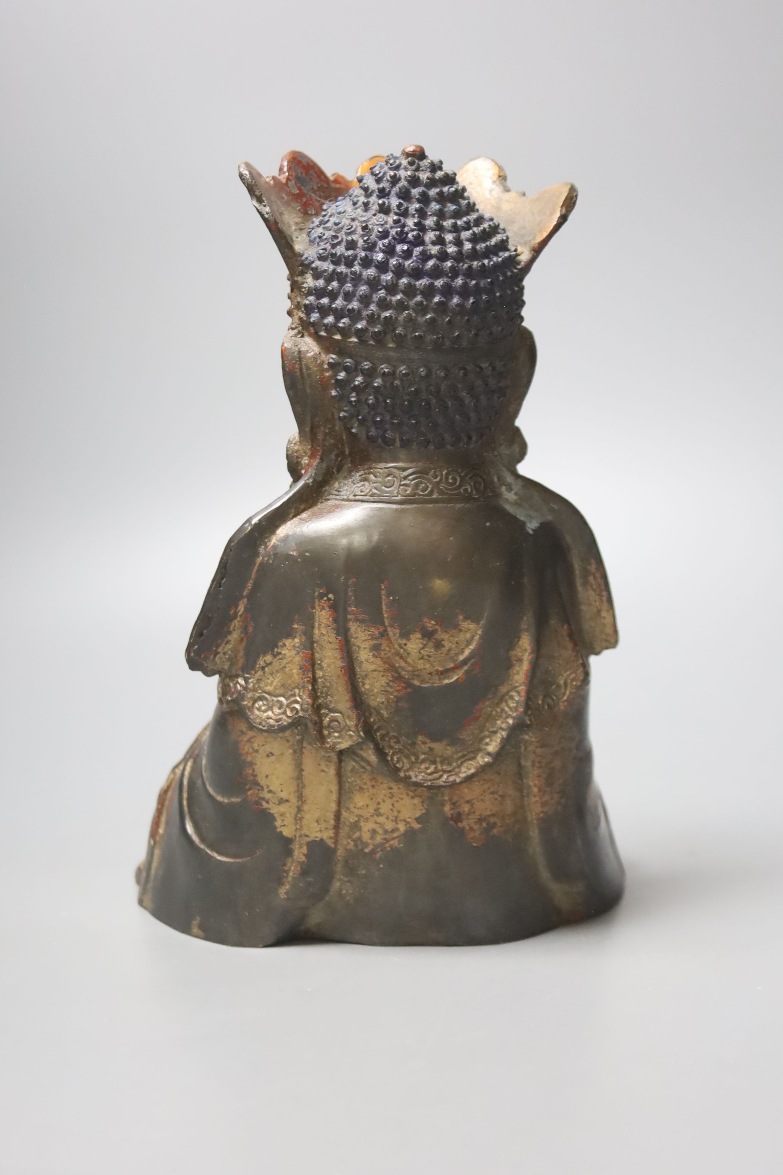 A Chinese gilt lacquered bronze figure of a seated and crowned Buddha, Ming dynasty or later, 21cm high